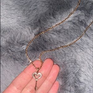 Rose gold heart key pendant.